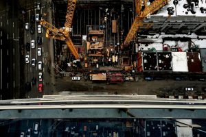 Aerial view of an urban construction site with cranes in Montreal cityscape.